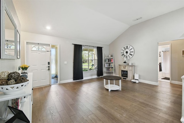 foyer featuring lofted ceiling and dark hardwood / wood-style floors