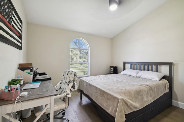 bedroom featuring lofted ceiling and dark hardwood / wood-style flooring