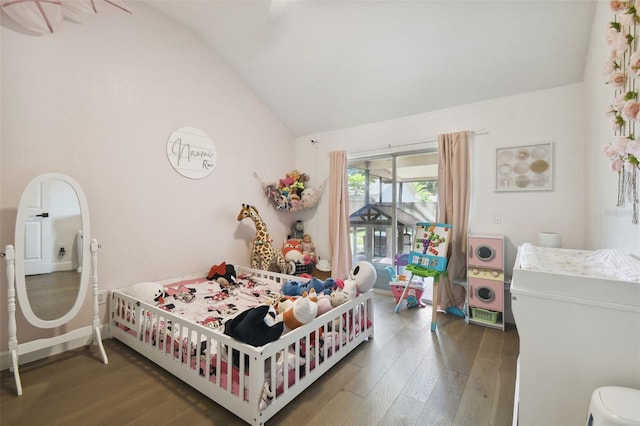 bedroom featuring lofted ceiling and dark hardwood / wood-style floors