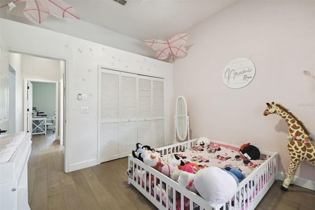 bedroom featuring wood-type flooring and a closet