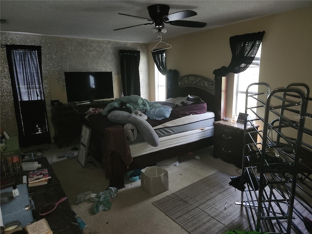 carpeted bedroom featuring a textured ceiling, multiple windows, and ceiling fan