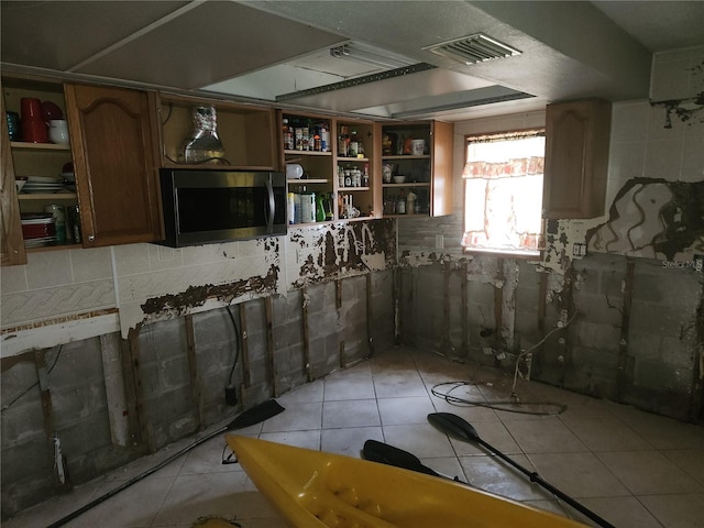 basement featuring light tile patterned floors