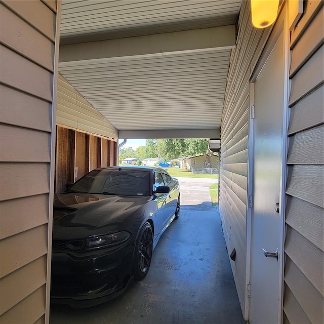 garage featuring wood walls and a carport