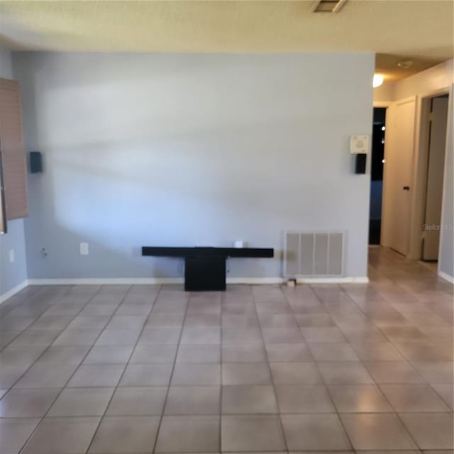 unfurnished room with light tile patterned floors