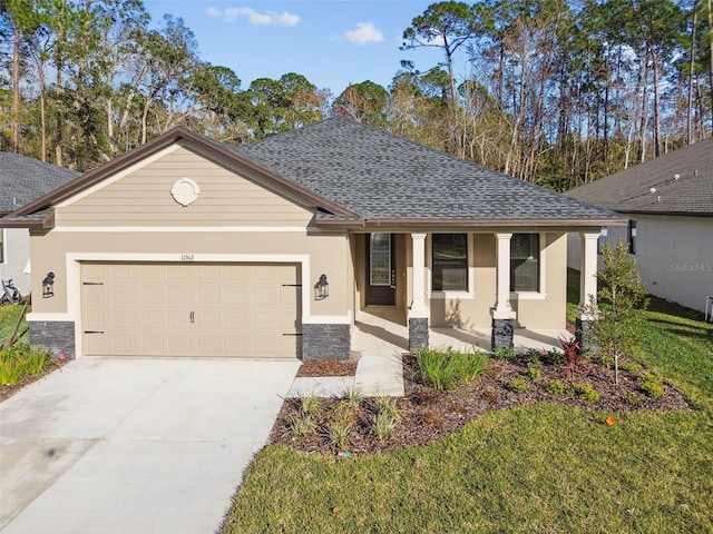 ranch-style house with a porch, a garage, and a front yard