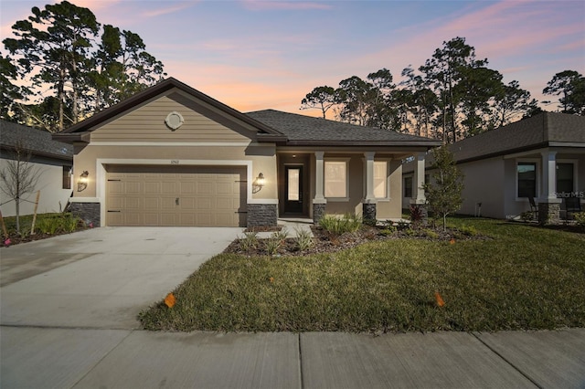 view of front of house featuring a garage and a yard