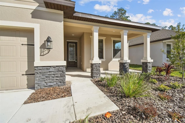 doorway to property with a porch and a garage