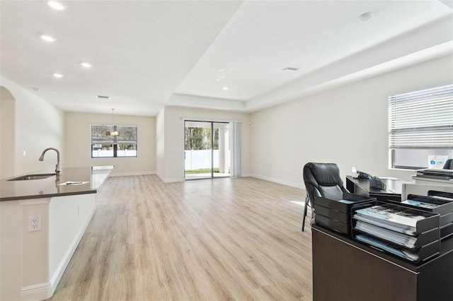 home office featuring sink and light wood-type flooring