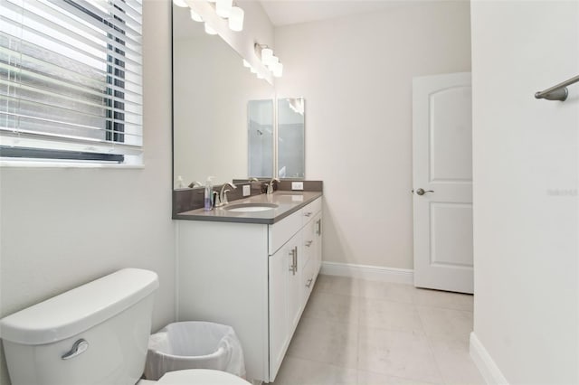 bathroom featuring tile patterned flooring, vanity, and toilet