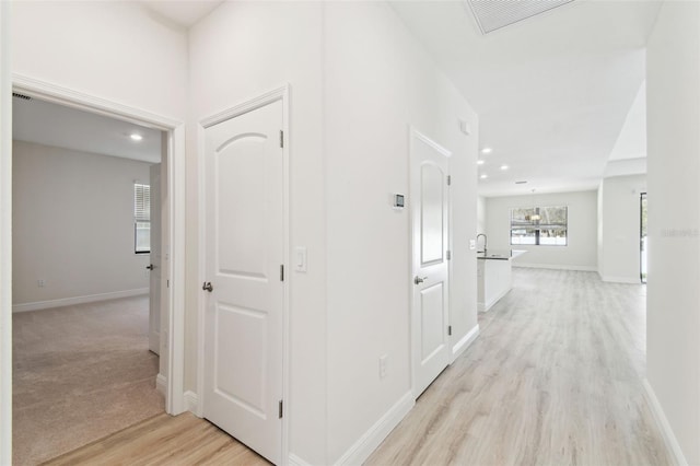 corridor featuring light hardwood / wood-style floors