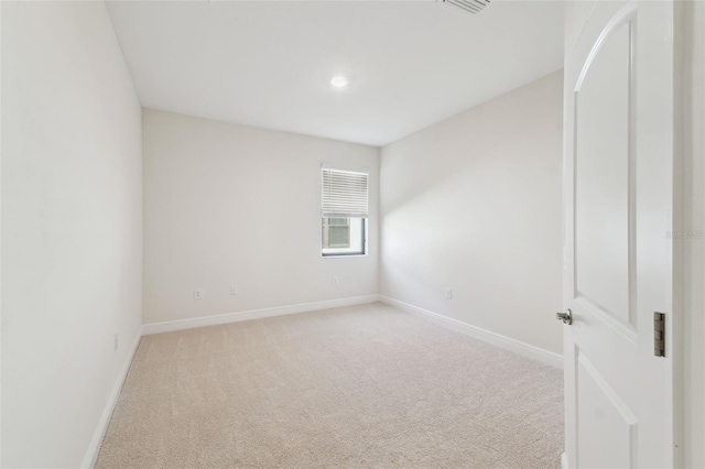 spare room with light colored carpet