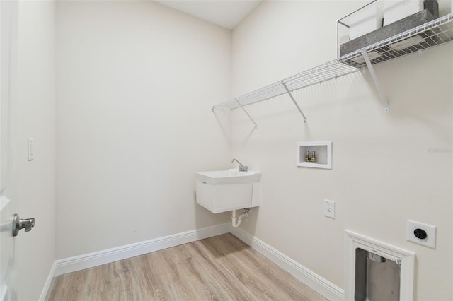 washroom with electric dryer hookup, washer hookup, and light wood-type flooring