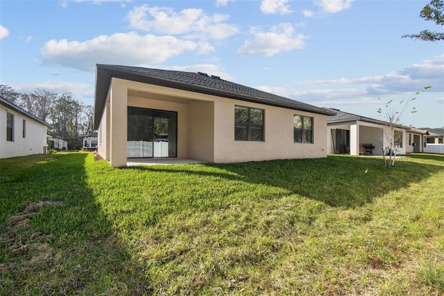 rear view of house featuring a yard