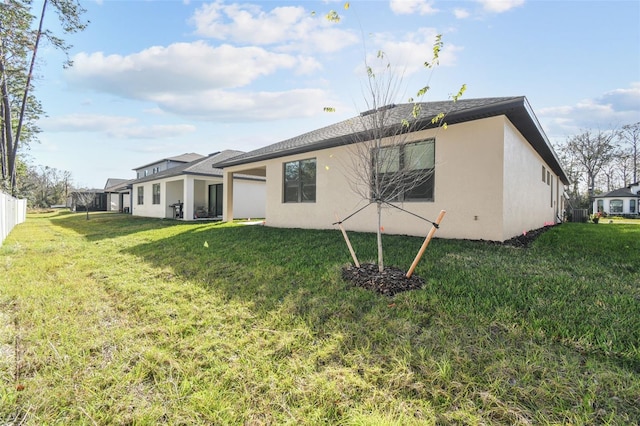 rear view of house featuring a yard