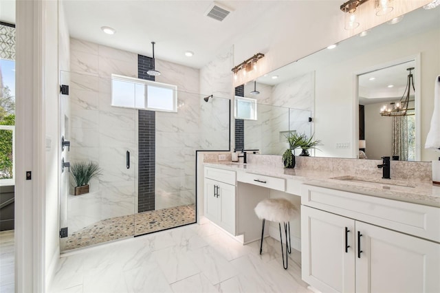 bathroom with vanity, walk in shower, and a chandelier