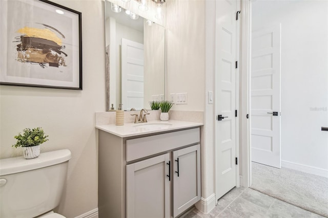 bathroom featuring vanity, toilet, and tile patterned floors