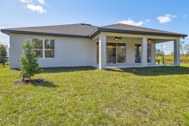 rear view of property featuring a yard, a patio area, and ceiling fan