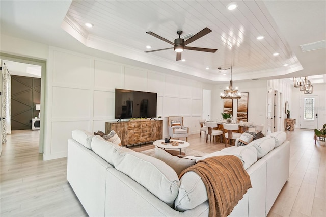11313 Limpkin Rd, Weeki Wachee, FL 34614 - living area with a raised ceiling, a chandelier, a decorative wall, a ceiling fan, and ornamental molding