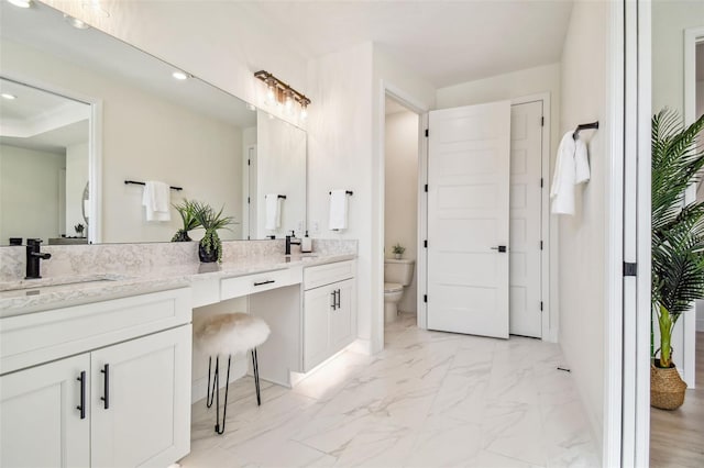 bathroom featuring vanity and toilet