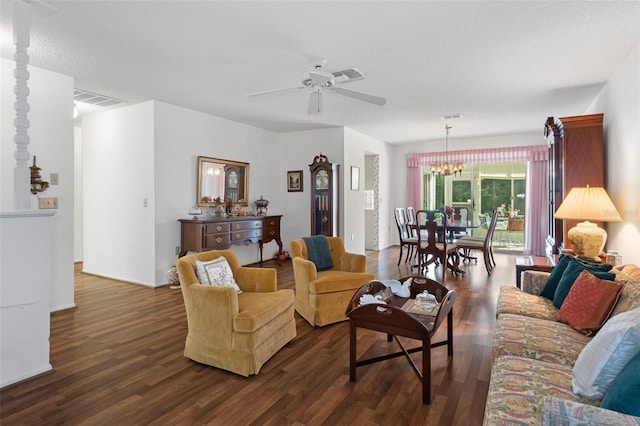 living room featuring a textured ceiling, ceiling fan with notable chandelier, and dark hardwood / wood-style flooring