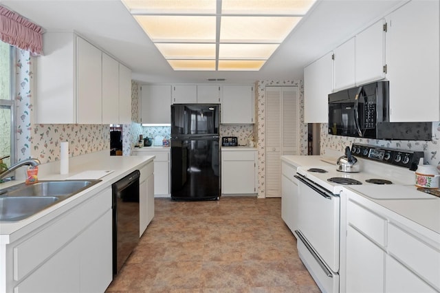 kitchen with sink, black appliances, and white cabinets