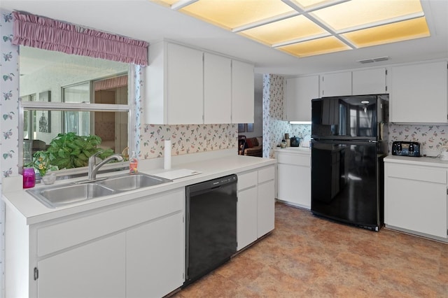 kitchen featuring white cabinetry, black appliances, and sink