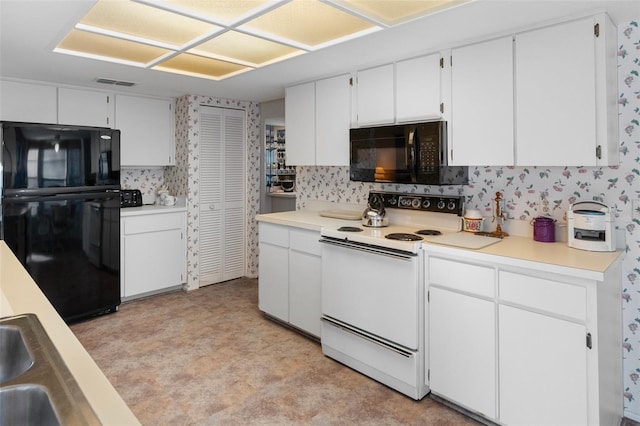 kitchen featuring white cabinetry and black appliances