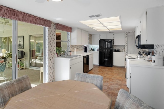 kitchen with ceiling fan, black appliances, sink, and white cabinets