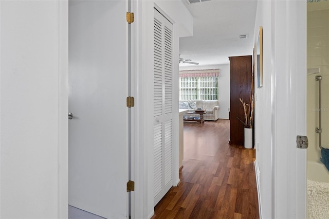 corridor featuring dark hardwood / wood-style floors