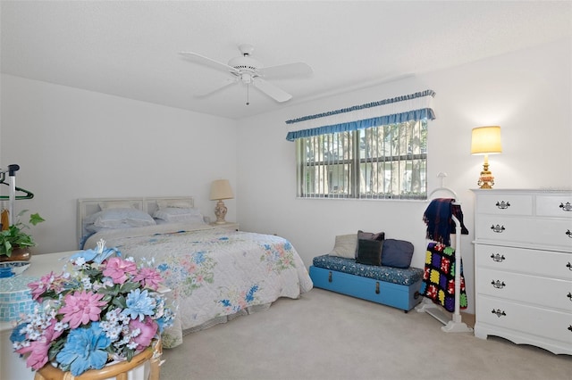 bedroom featuring ceiling fan and light carpet