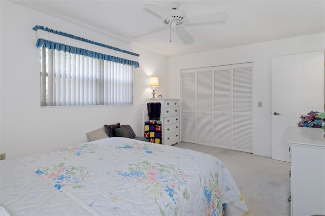 bedroom featuring a closet, ceiling fan, and light carpet