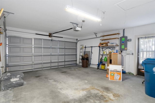 garage with a garage door opener and electric panel