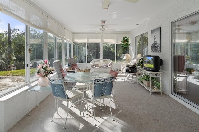 sunroom featuring a healthy amount of sunlight and ceiling fan