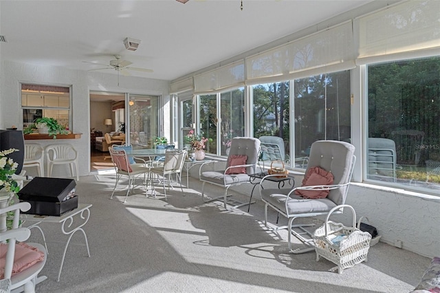 sunroom featuring ceiling fan