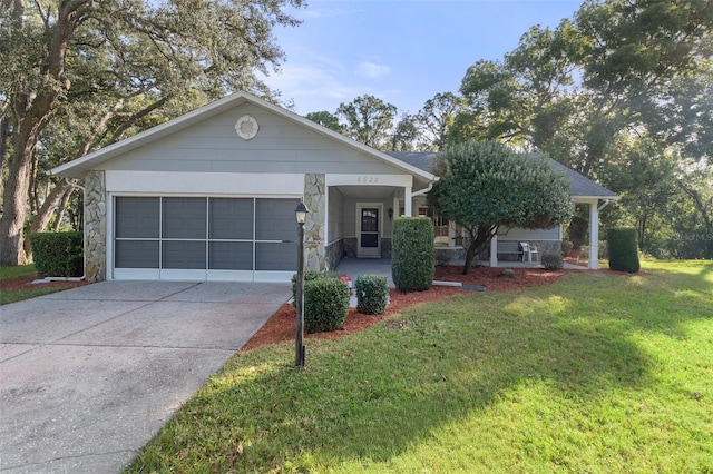 ranch-style house featuring a front lawn and a garage