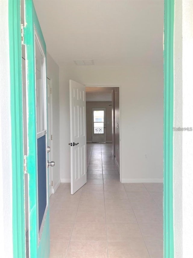 corridor with light tile patterned floors