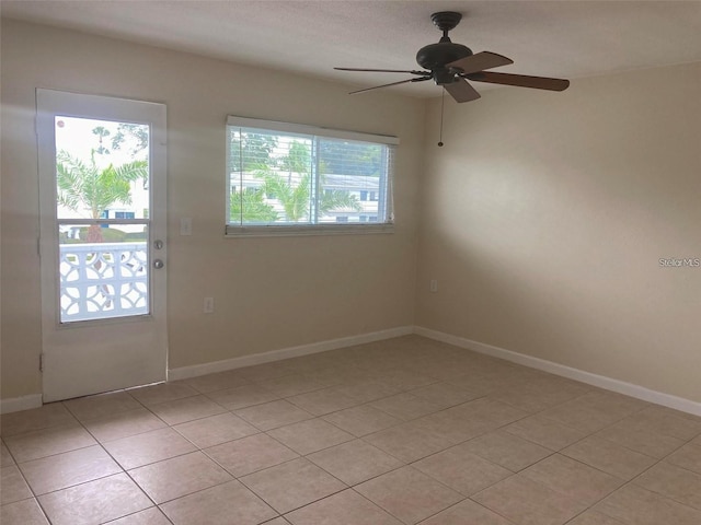 unfurnished room with light tile patterned flooring and ceiling fan