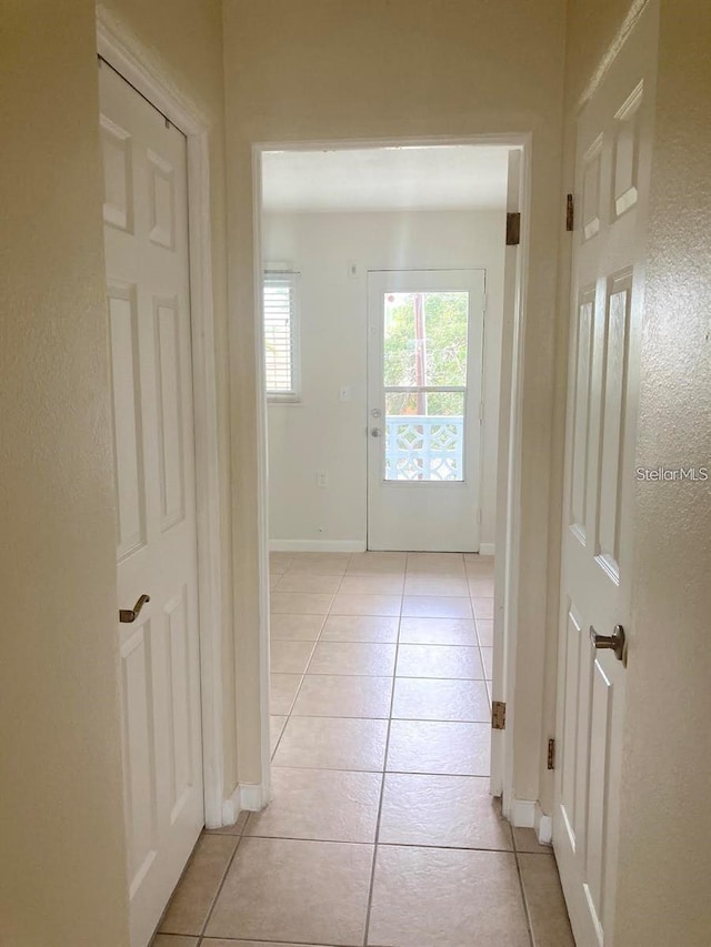 hallway with light tile patterned floors