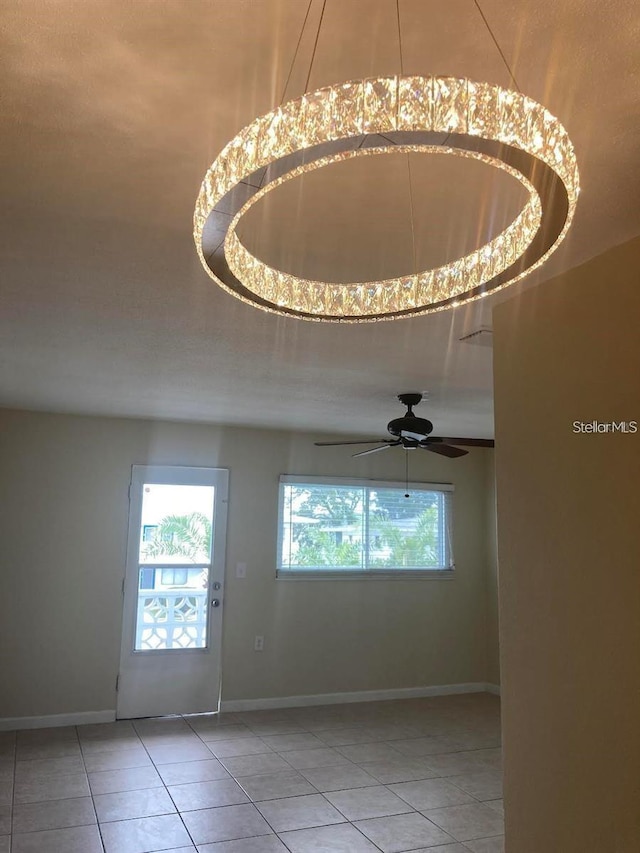 tiled spare room with ceiling fan