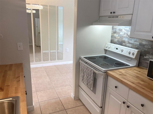 kitchen featuring white cabinets, wooden counters, decorative light fixtures, backsplash, and electric range