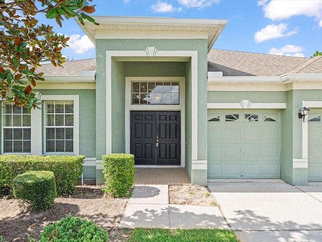 view of exterior entry with a garage