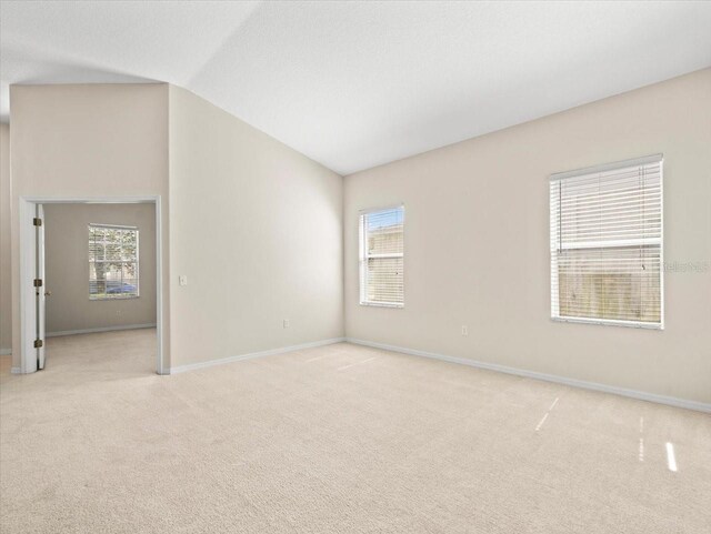 4264 Braemere Dr, Spring Hill, FL 34609 - unfurnished room with light carpet, healthy amount of natural light, and lofted ceiling