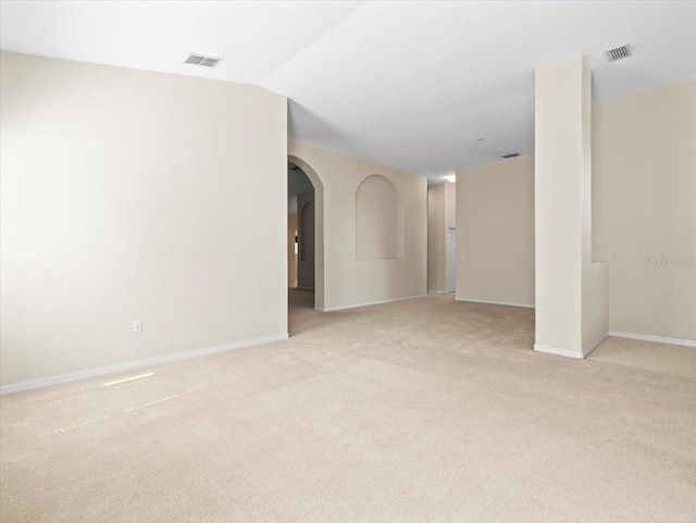 4264 Braemere Dr, Spring Hill, FL 34609 - spare room featuring light carpet, arched walkways, baseboards, and lofted ceiling