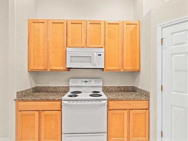 4264 Braemere Dr, Spring Hill, FL 34609 - kitchen featuring white appliances and dark stone counters