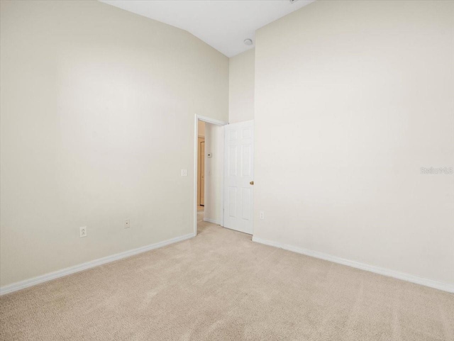 4264 Braemere Dr, Spring Hill, FL 34609 - unfurnished room featuring light carpet, baseboards, and high vaulted ceiling