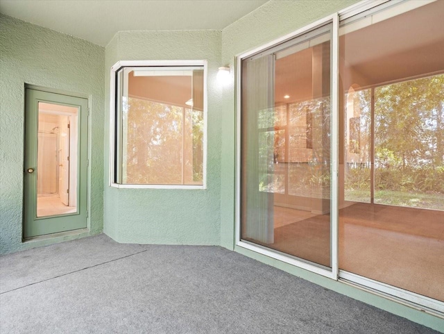 4264 Braemere Dr, Spring Hill, FL 34609 - view of exterior entry with stucco siding and a patio