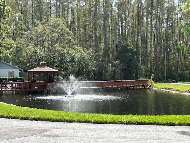 surrounding community featuring a water view and a gazebo