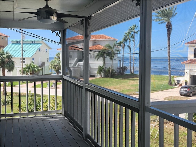 deck featuring ceiling fan and a lawn