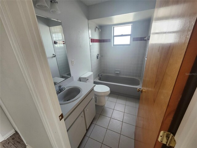 bathroom featuring vanity, shower / bathing tub combination, tile patterned floors, and toilet
