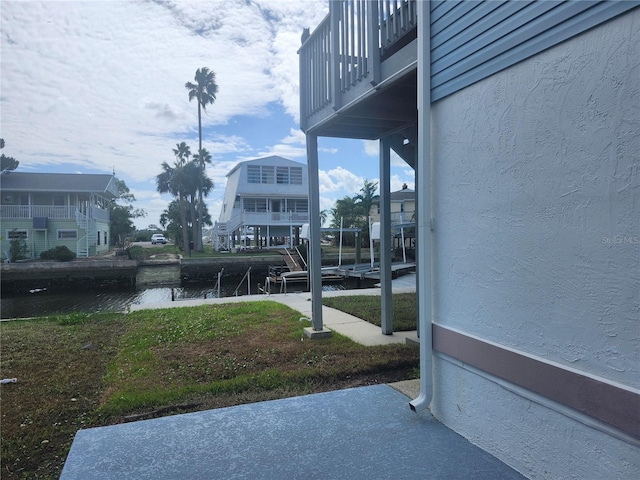 view of yard featuring a water view and a balcony